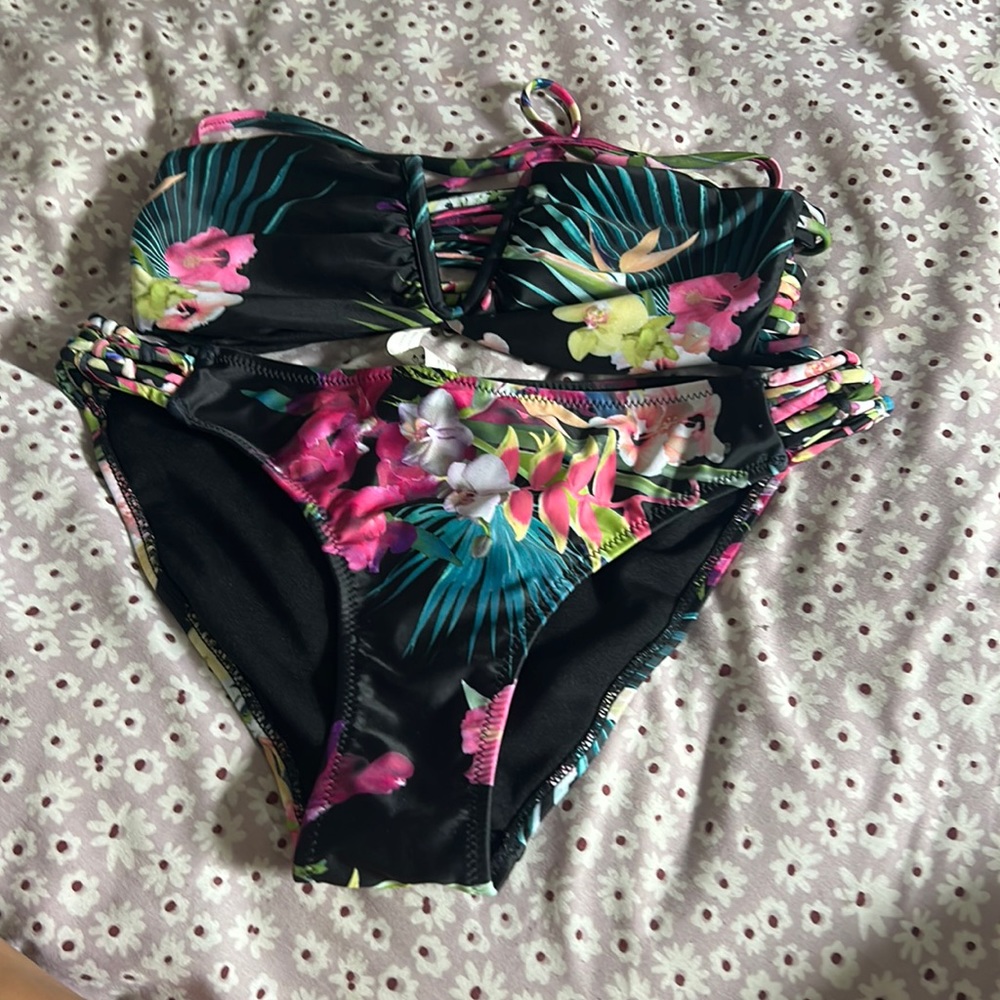 Three. Swimsuits two pieces. All have floral prints
